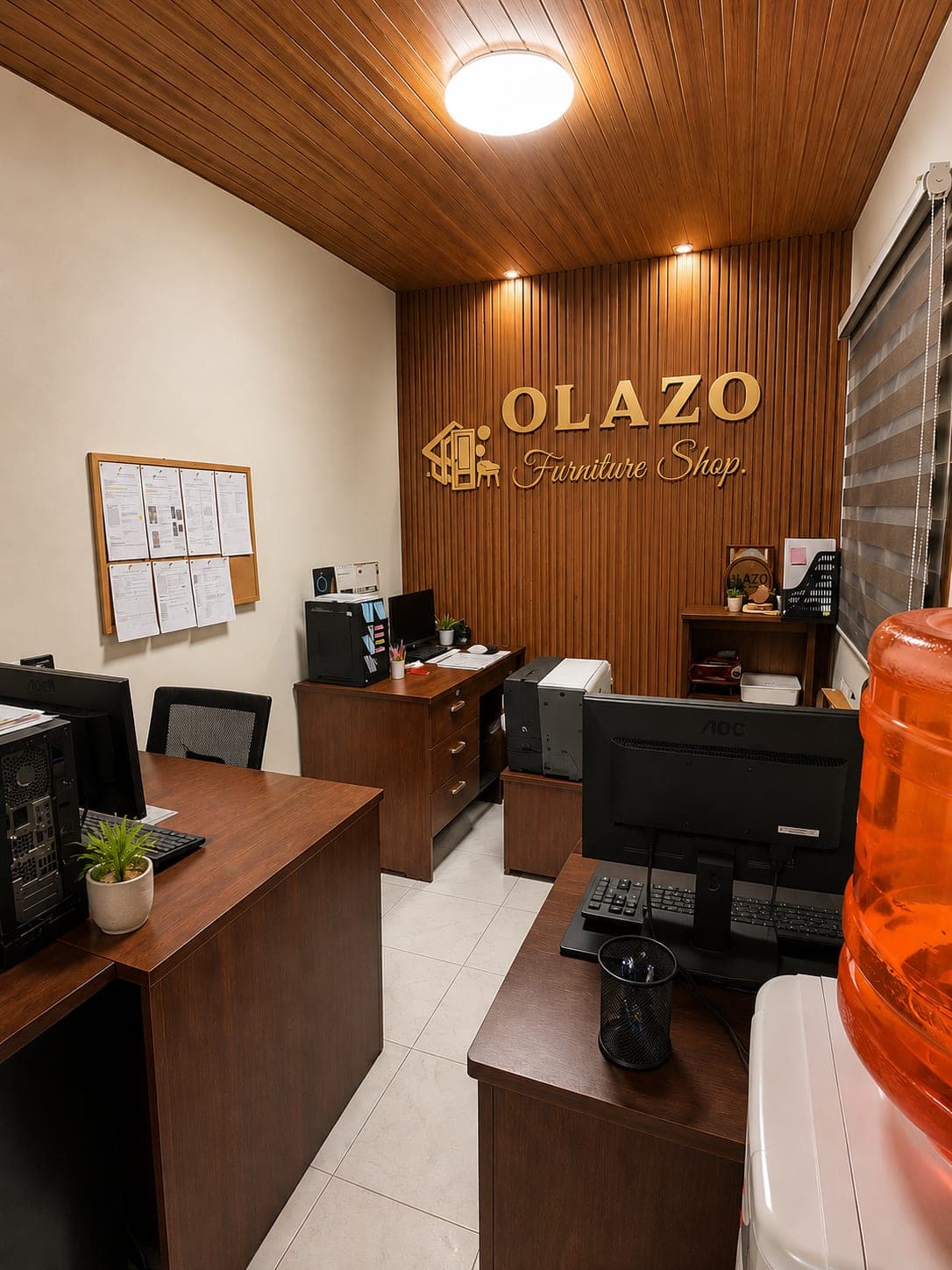 The OLAZO office, desks and computers beneath the OLAZO Furniture Shop sign on a slatted timber wall