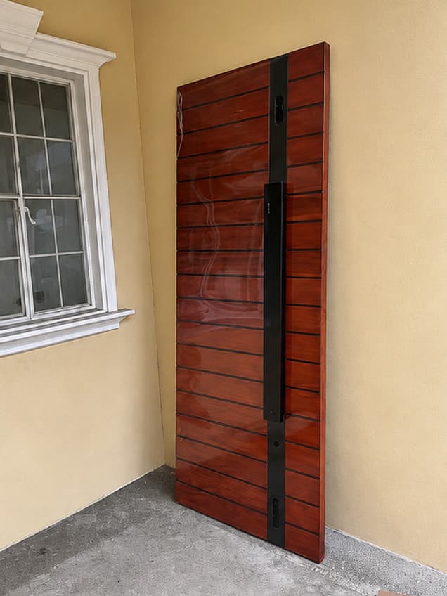 The August-45 door by OLAZO Furniture — a grooved door with a long dark handle, fitted in place