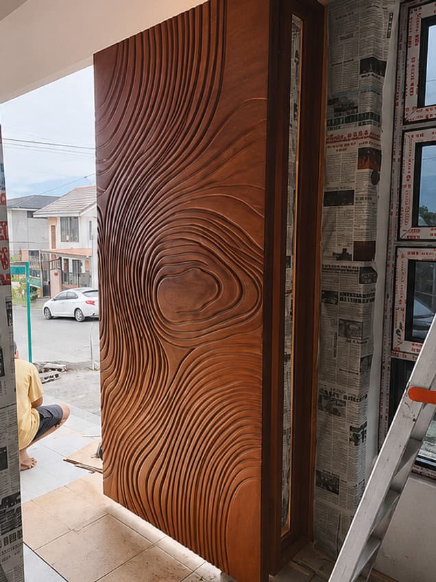 The Crafted-34 door by OLAZO Furniture — carved in concentric contours that follow the wood grain