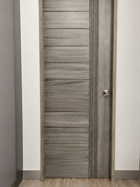The Gray D-14 door by OLAZO Furniture — a pale grey-washed door beside a fluted strip